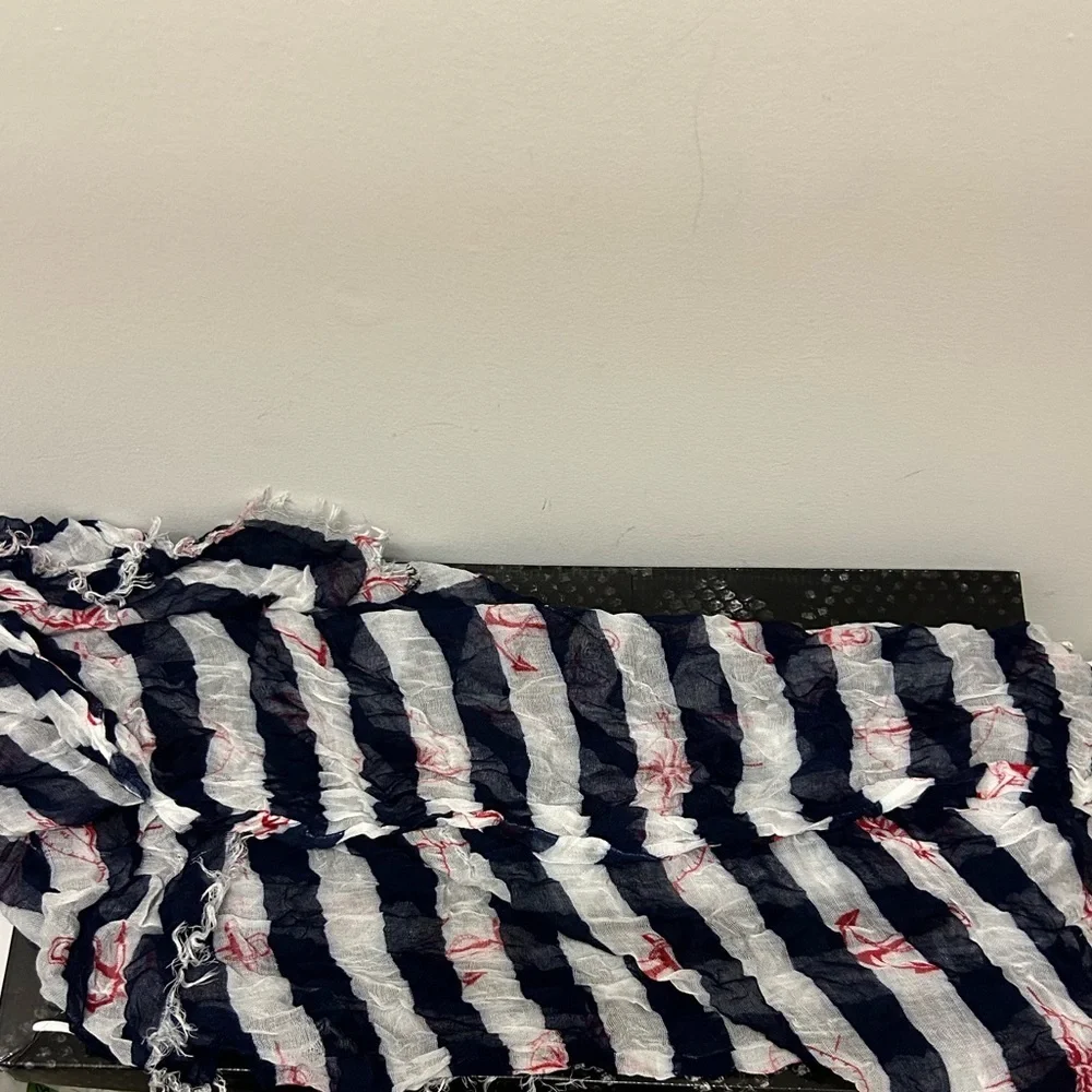 Blue and white striped scarf with red details.